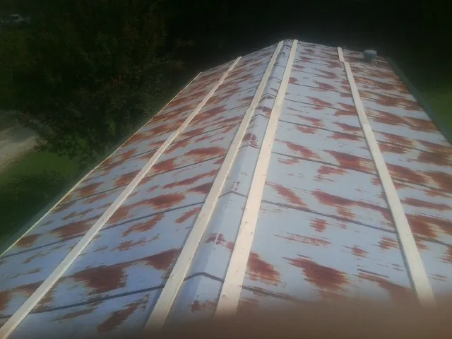 Rusted metal roof panels with new wood purlins before replacement — Storm Damage Roof Repair in Water Mill by Roofing Brothers