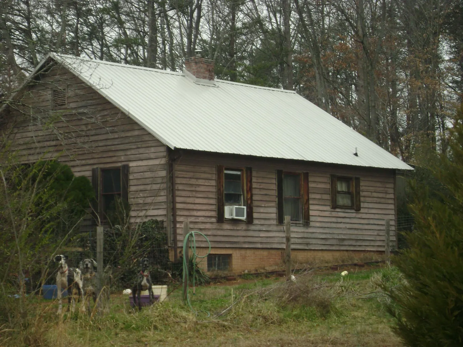 White metal roof on an old wood sided farmhouse, from a Metal Roof Installation job in Water Mill